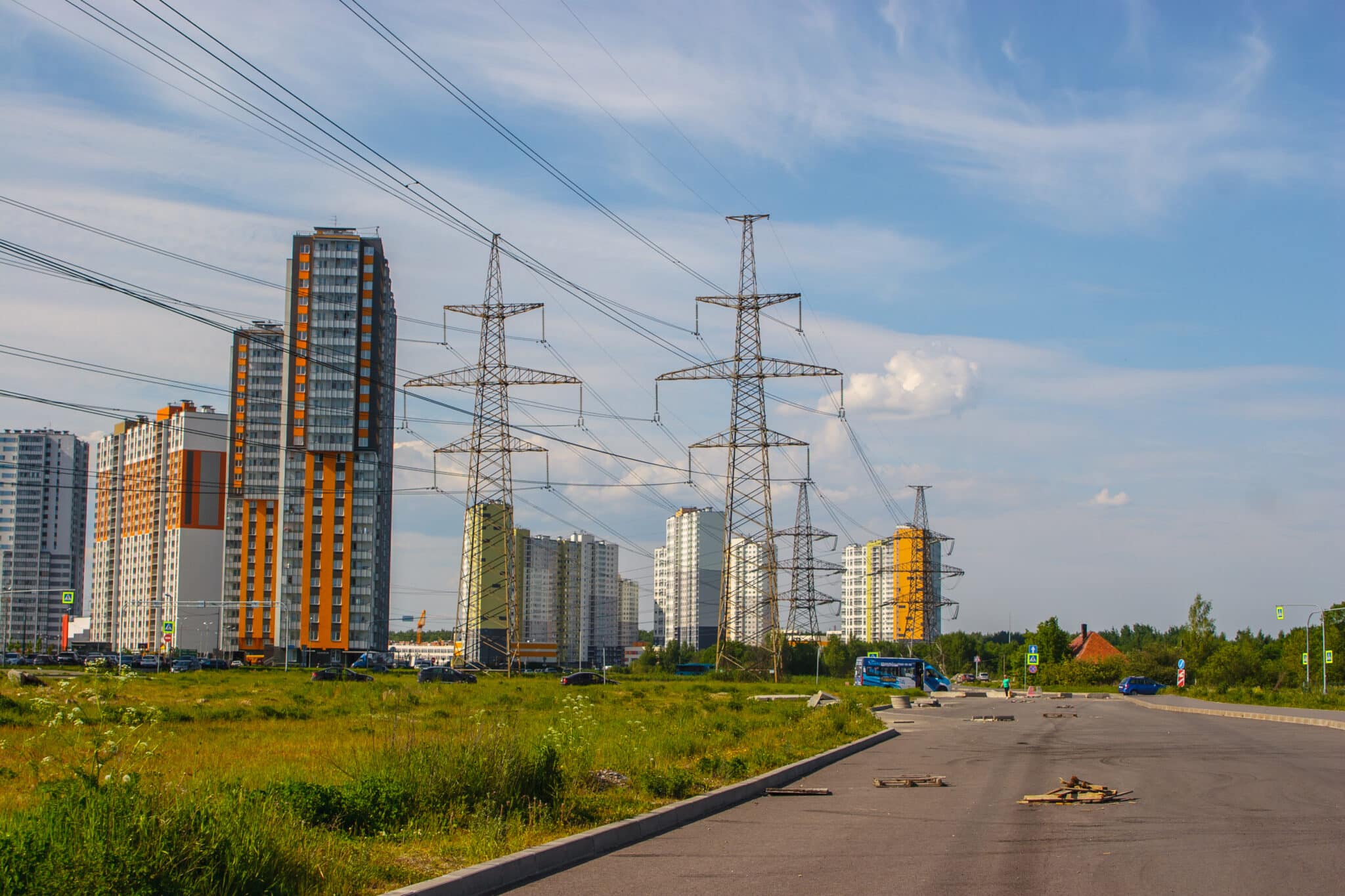Tall apartment buildings and electricity towers in city