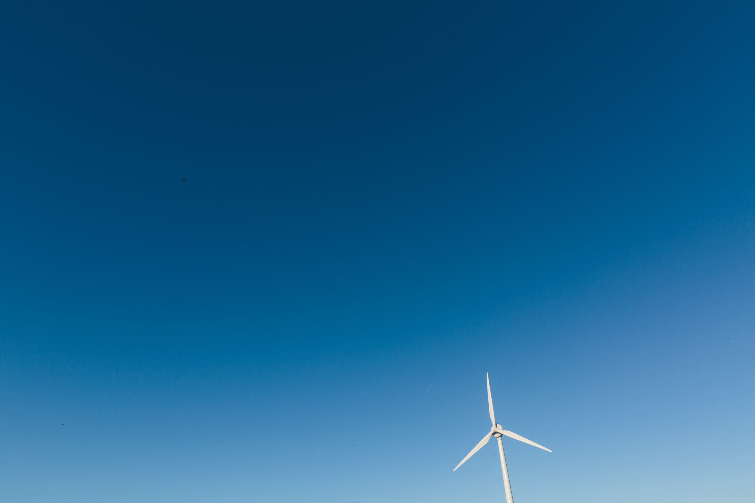 photo of white wind turbine during daytime