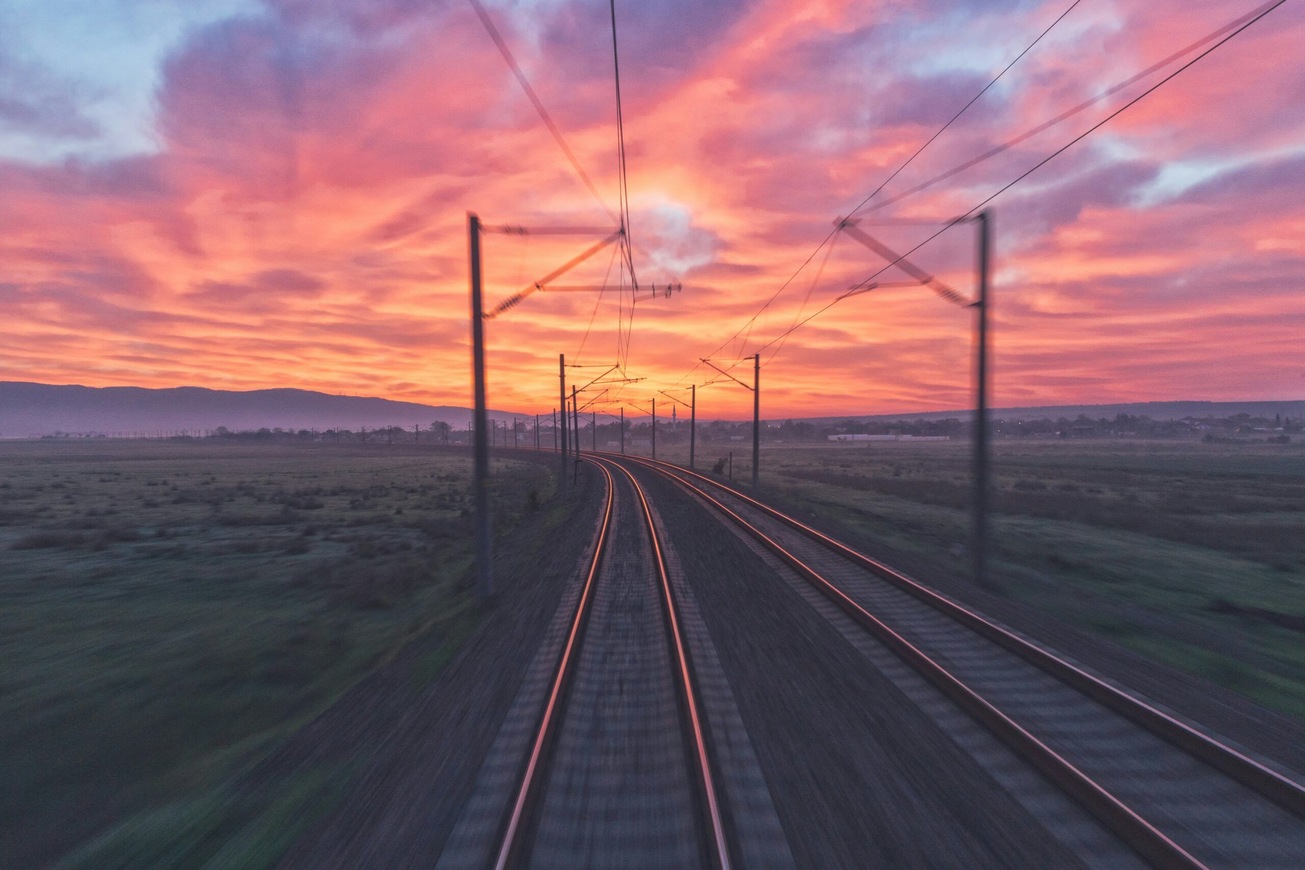 On board a train that zooms into the sunrise.