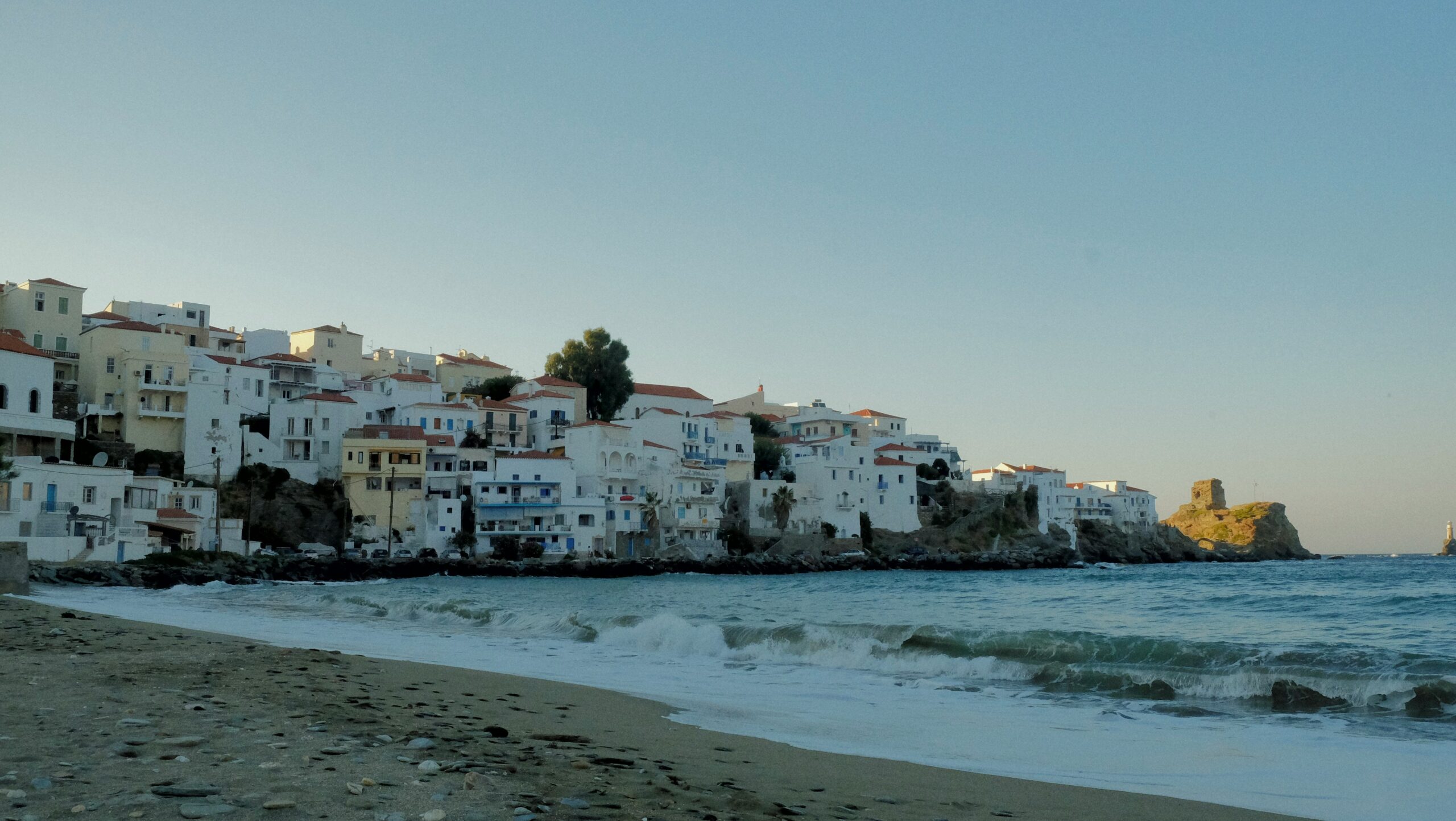 a beach with buildings along it